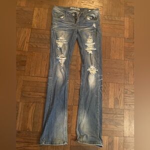 Machine distressed ripped jeans